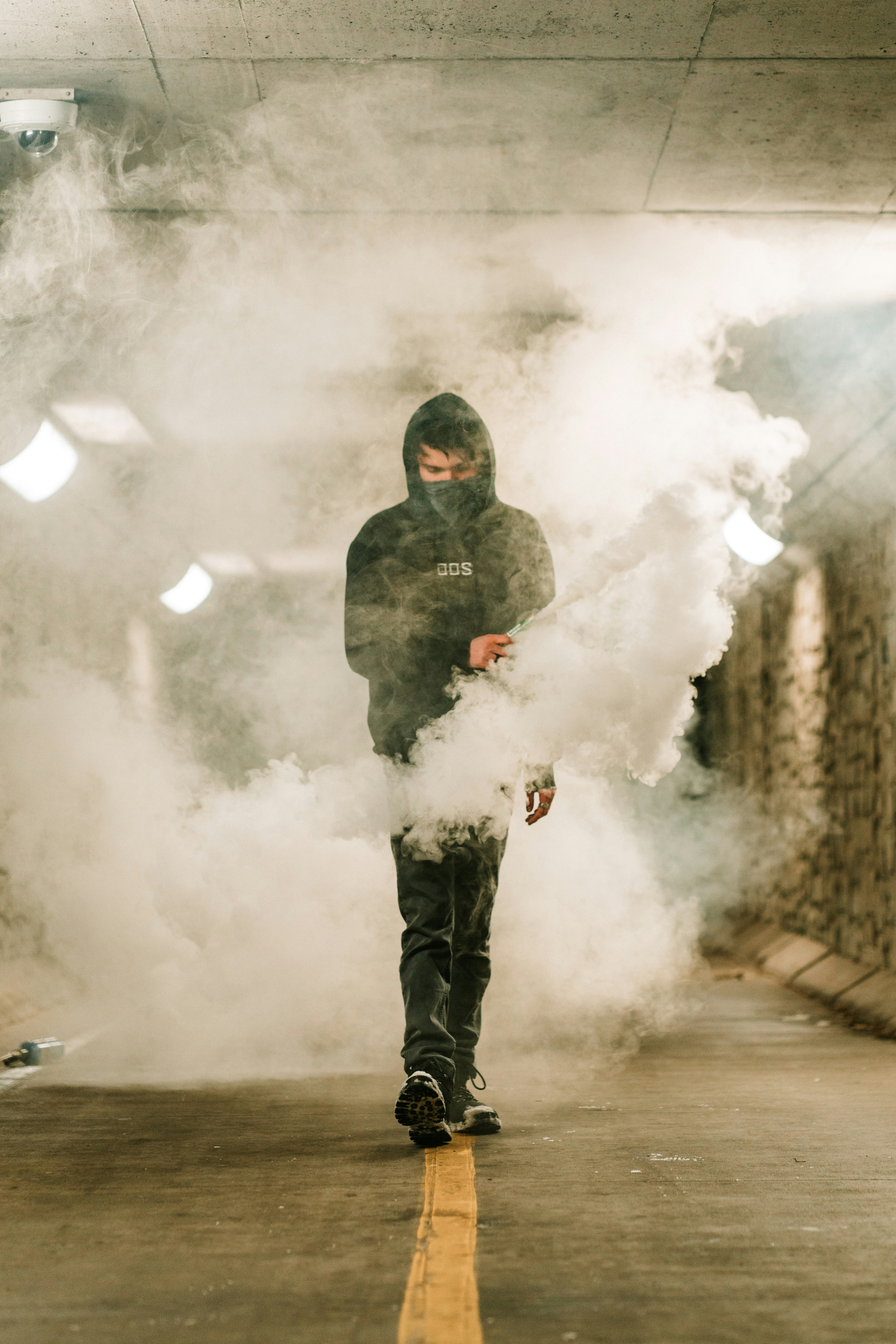 man in black jacket and black pants holding white smoke
